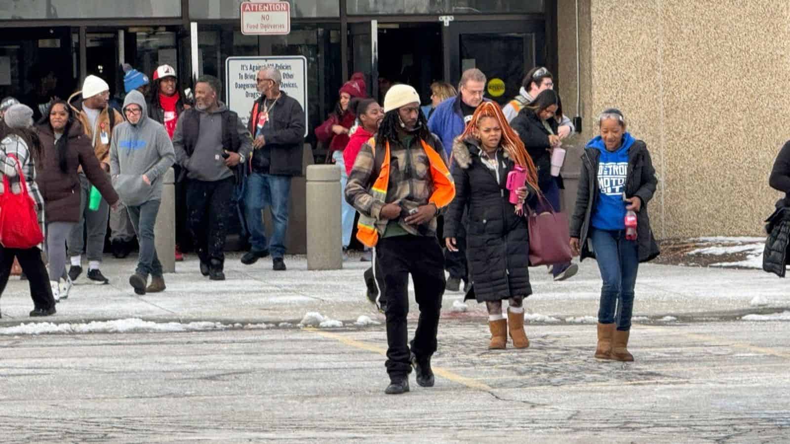 Workers leaving a GM plant after layoff notices